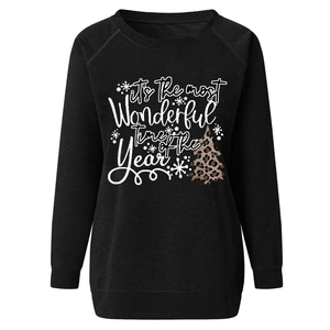 Close-up of a black sweatshirt with leopard print Christmas tree and festive lettering