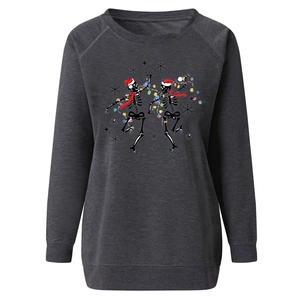 Close-up of festive skull print with Christmas hat and lights on grey sweatshirt
