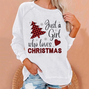 Close-up of white sweatshirt featuring plaid Christmas tree print and festive text detail