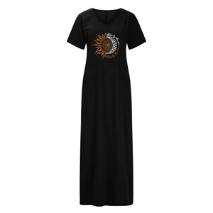 Detail of V-neckline and sun-moon print on a black dandelion theme maxi dress