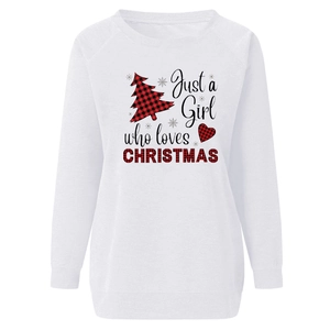 Detail of Christmas sweatshirt featuring red plaid tree and heart themed graphic print