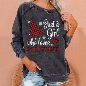 Detail view of the acid wash grey sweatshirt fabric and Christmas tree printed graphic