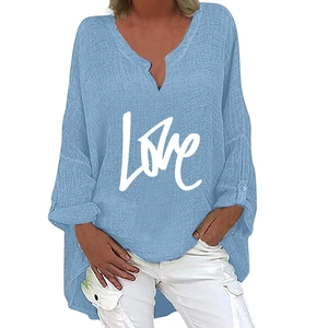 Detail of light blue oversized V-neck blouse with white LOVE print and curved hemline