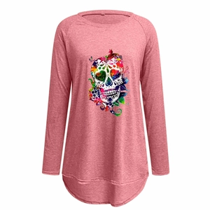 Detail of raglan sleeves and colorful sugar skull print on a pink long sleeve t-shirt