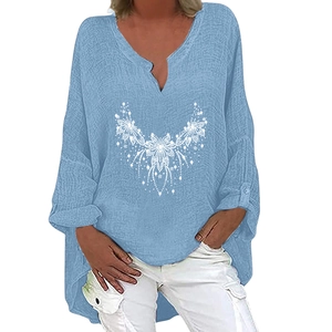 Detail of light blue V-neck linen blouse with white creative print pattern and asymmetric hem