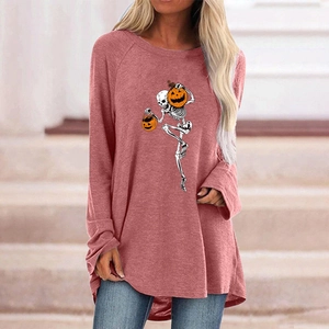 Close-up of Halloween skull and pumpkin print on a loose brick-red long-sleeve tee