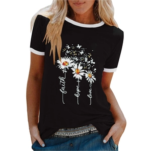 Close-up of black t-shirt featuring daisy prints and faith hope love lettering