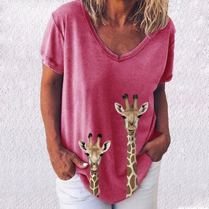 Detail of V-neck rose pink t-shirt featuring realistic giraffe print on the bottom hem