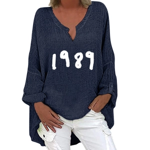 Detail of navy blue V-neck linen shirt with white 1989 print and irregular hem