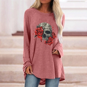 Detail of Gothic skull and red rose print on a brick red long sleeve tunic top