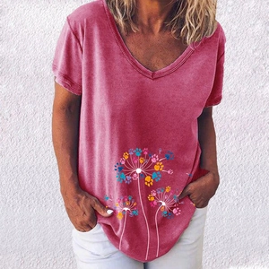 Detail of elegant V-neck pink T-shirt featuring colorful paw print dandelion graphics