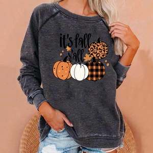 Detail of the oversized Halloween sweatshirt featuring fall pumpkin prints and text