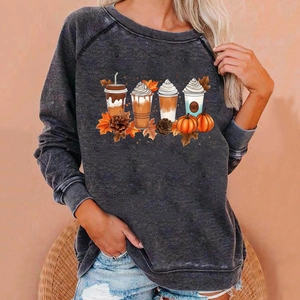 Close-up of acid wash grey sweatshirt featuring detailed autumn coffee and pumpkin prints