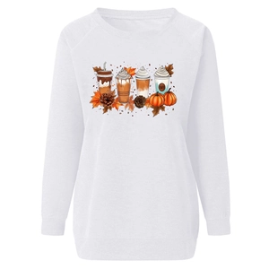 Detail of autumn pumpkin and coffee print on white crewneck sweatshirt fabric