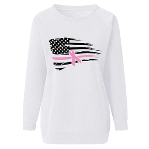 Detail of soft white crewneck sweatshirt featuring pink ribbon and US flag print
