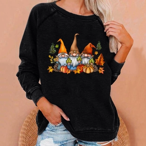 Detail of loose black Halloween sweatshirt featuring autumn gnomes and pumpkins print