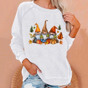 Detail of loose white sweatshirt with colorful autumn gnomes and pumpkin prints