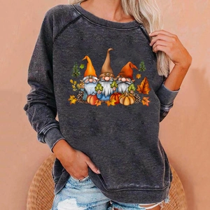 Detail of loose fit grey Halloween sweatshirt featuring three festive gnomes and autumn elements