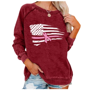 Detail of burgundy sweatshirt featuring a breast cancer awareness flag print and ribbed cuffs