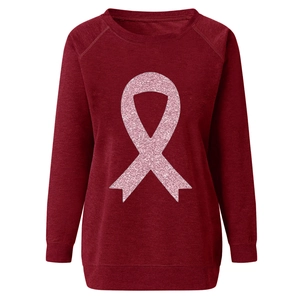 Close-up of raglan sleeves and rib-knit cuffs on a thick burgundy sweatshirt