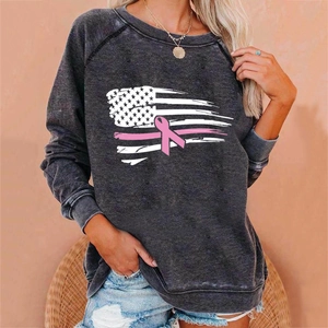 Detailed view of pink ribbon breast cancer awareness print on dark grey sweatshirt