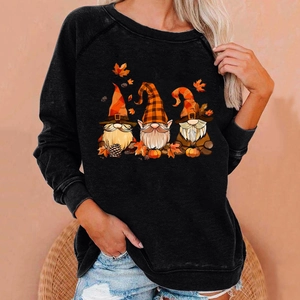 Detail of fall gnome print on black crewneck sweatshirt with pumpkin and maple leaf icons