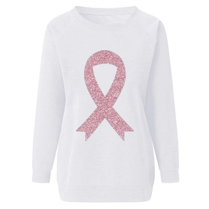 Close-up of pink glitter ribbon print on white sweatshirt with soft fabric texture