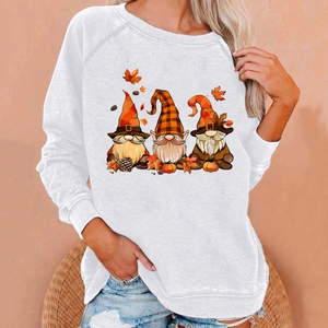 Detail of white Halloween sweatshirt featuring festive gnomes and autumn maple leaves
