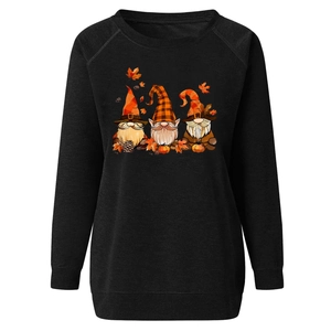 Close-up of Halloween gnomes and pumpkin print on a black women's sweatshirt