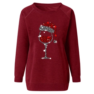 Detailed view of wine glass and Santa hat sequin print on wine red raglan sleeve sweatshirt