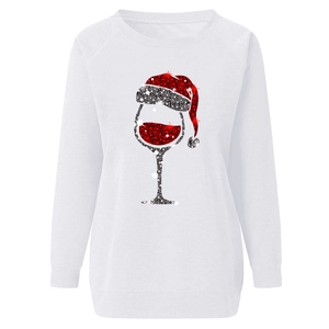 Detail of Christmas wine glass with santa hat print on white crewneck sweatshirt