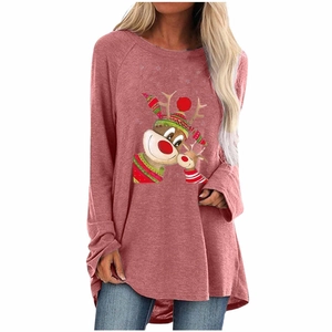 Detail of Christmas reindeer print on a loose brick red long sleeve holiday shirt