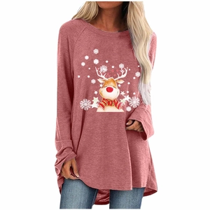 Close-up of pink long-sleeve sweatshirt featuring reindeer print and white snowflakes