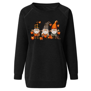 Close-up of fall gnomes print and maple leaf detail on black raglan sweatshirt