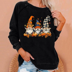 Detail of three gnomes pumpkin print on a black loose cotton blend sweatshirt