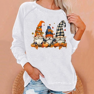 Close-up of white Halloween hoodie featuring three gnomes with pumpkins and fall maple leaves