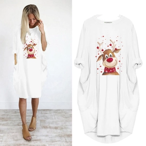 Detail of Christmas reindeer print and side pockets on a white long sleeve dress