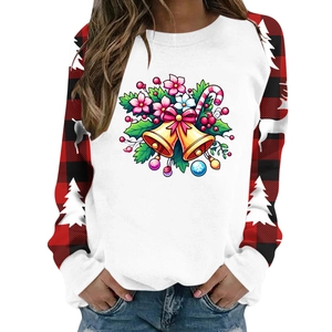 Detail of Christmas sweatshirt featuring holiday bell prints and red plaid raglan sleeves