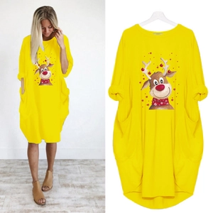 Detail of yellow Christmas dress featuring reindeer print, long sleeves and side pockets