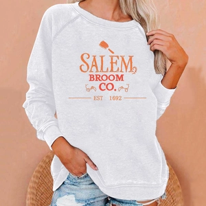 Close-up of Salem Broom Co. vintage print on a white long sleeve Halloween sweatshirt