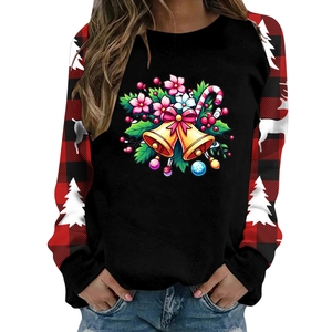Detail of Christmas sweatshirt featuring festive bell prints and red buffalo plaid sleeves