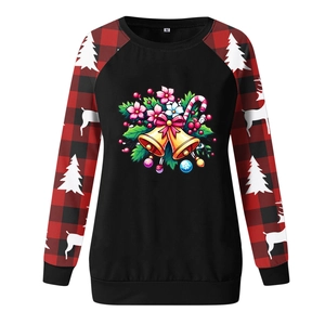 Close-up of a Christmas sweatshirt detail with festive bells and reindeer patterns