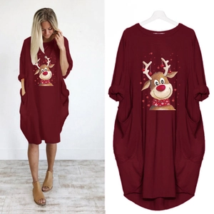 Detail of burgundy Christmas dress featuring reindeer print, long sleeves and side pockets