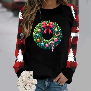 Close-up of Christmas wreath print and buffalo plaid sleeves on thick sweatshirt