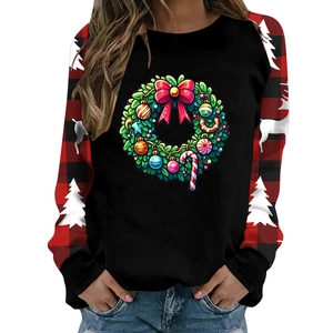 Close-up of Christmas wreath print and red-black plaid patchwork on a thick sweatshirt