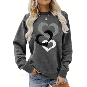 Detailed view of the three overlapping heart prints on a grey crewneck sweatshirt