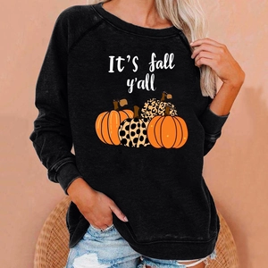 Detail of Halloween pumpkin print and 'It's fall y'all' lettering on cozy black sweatshirt