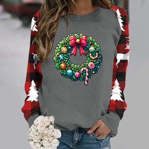 Detail of Christmas sweatshirt with festive wreath print and red buffalo plaid sleeves