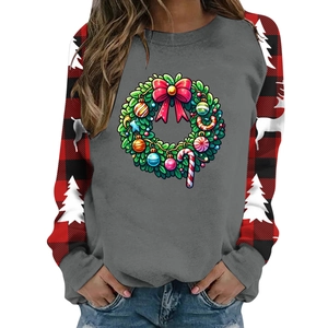 Close-up of Christmas sweater with red plaid sleeves and festive reindeer holiday print