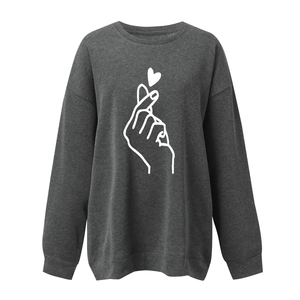 Detail view of the ribbed cuffs and hem on this dark grey finger heart print sweatshirt